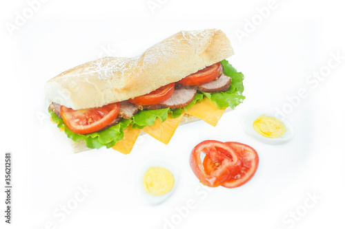 Big tasty sandwich with tomato lettuce with soap and ham on a white background