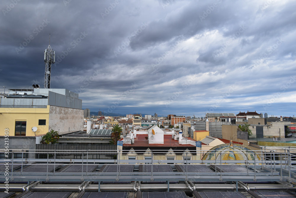 Storm about to fall over the city of Barcelona, gray and cloudy sky, popular houses Storm about to fall over the city of Barcelona, gray and cloudy sky, popular houses