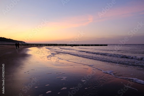 Beautiful sunset colors on the beach of sea and amazing reflection in water.