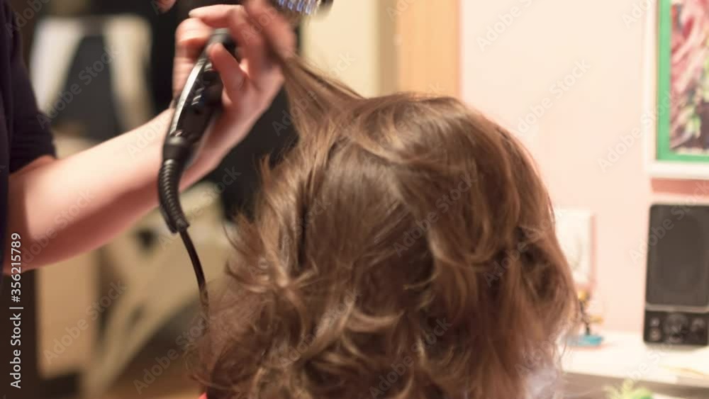 Single mother drying hair to her adorable daughter in bathrobe Single mother drying hair to her adorable daughter in bathrobe