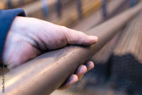 hand holding metal pipe