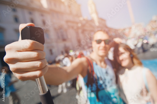 Happy couple lover tourist taking selfie photo on background fountain Four rivers in Piazza Navona, Rome Italy