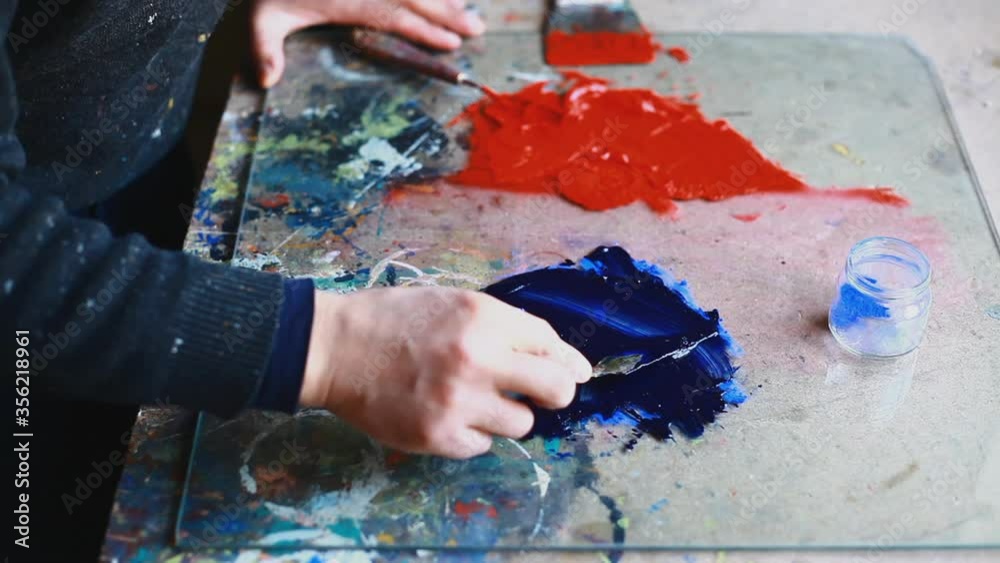 CU Woman adding pigment to paint and mixing with spatula / Yekaterinburg, Ural, Russia CU Woman adding pigment to paint and mixing with spatula / Yekaterinburg, Ural, Russia