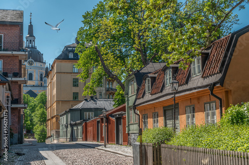 Old houses in Stockholm. Sodermalm district. Sweden. Scandinavia. View with Katarina kyrka (Church of Catherine). photo