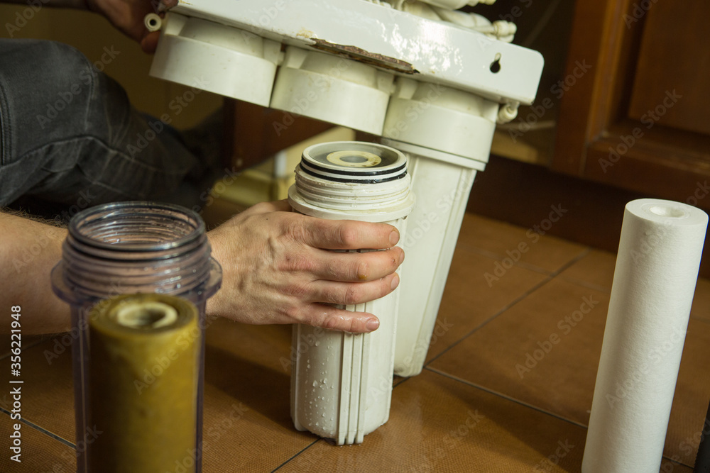 Changing filters in your home water purification system. The master