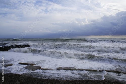 Storm, strong waves, sea coast, pebbles on the beach