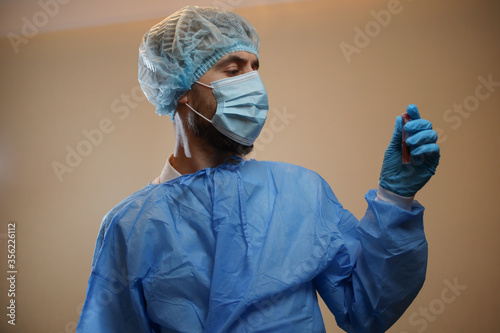 The concept of preventing the spread of the epidemic and treating coronavirus. The doctor points to a test tube with a blood test. Coronavirus treatment. Doctor.