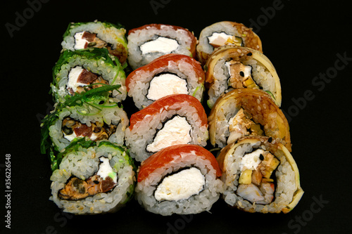 Large set of Delicious sushi rolls. A lot assortment Philadelphia roll Dishes from Japanese raw fish. Japan food menu service