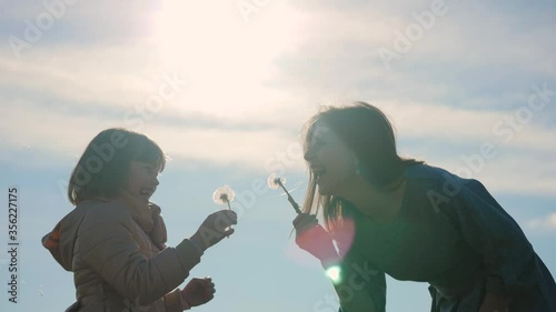 Happy Mother and her little Daughter playing together