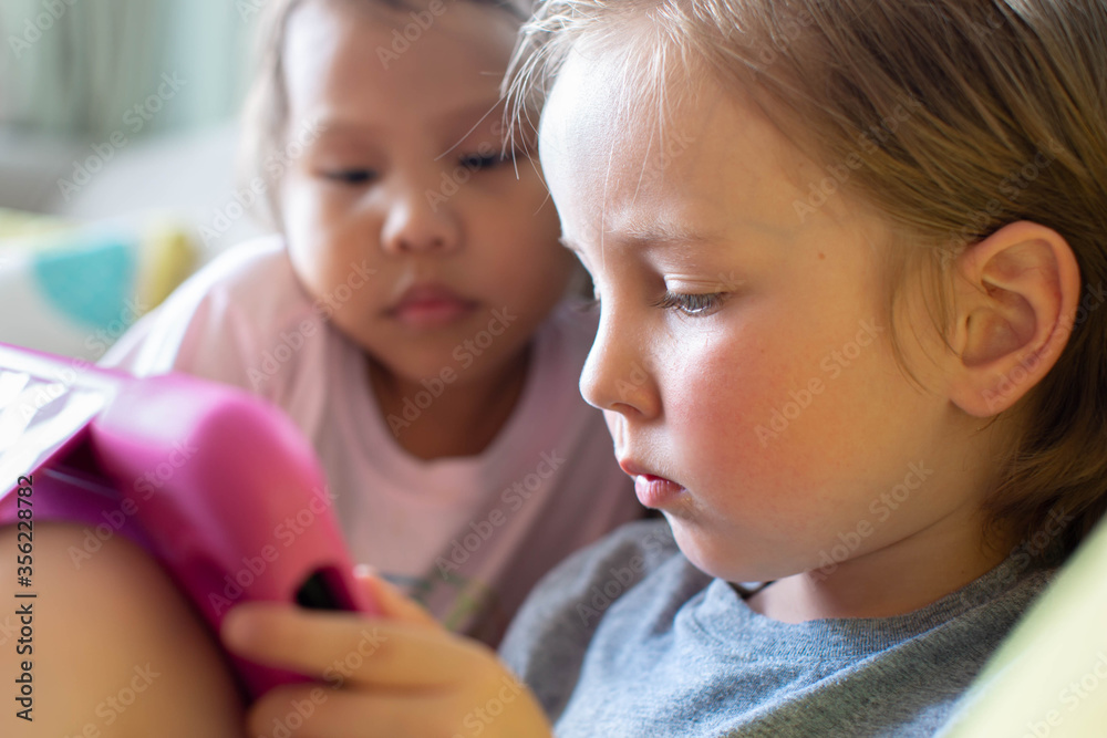 Kids watching tv on a tablet. Children learning online. Kids watching tv on a tablet. Children learning online.