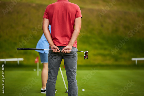 Guy with a golf club in his hands.