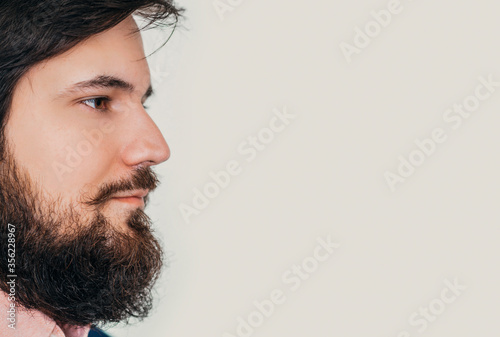 Barbershop banner. Closeup portrait of Bearded man with face in profile photo