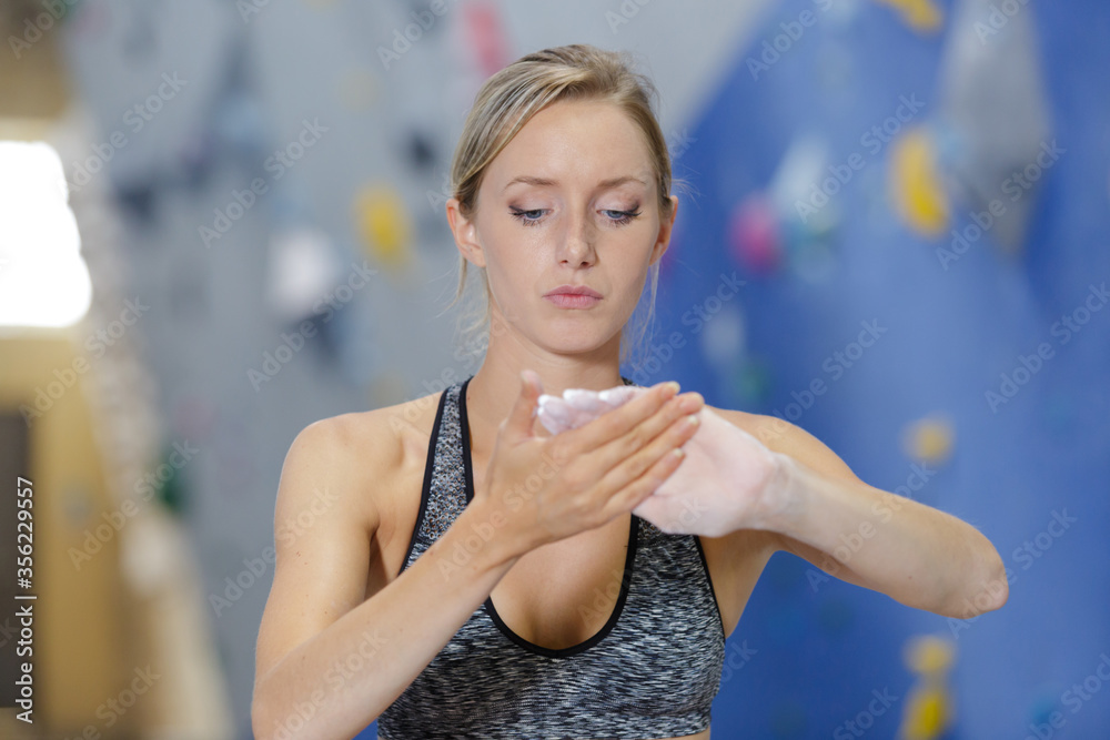 female climber preparing hands with magnesium female climber preparing hands with magnesium
