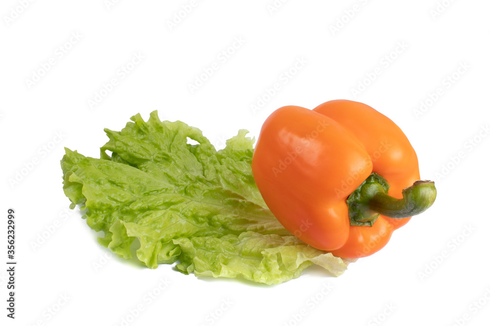 Orange pepper on lettuce leaf isolated on white background. Food concept. Orange pepper on lettuce leaf isolated on white background. Food concept.