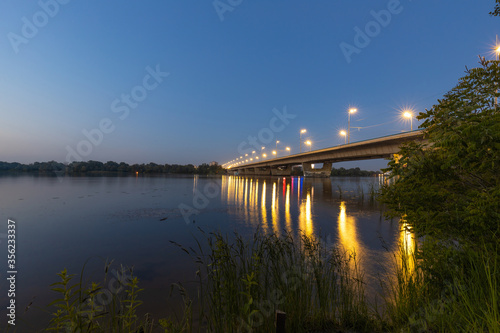 Beautiful evening landscape with a transport bridge and a river