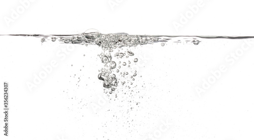 Water poured into tank, bubbles and splashes visible on white background
