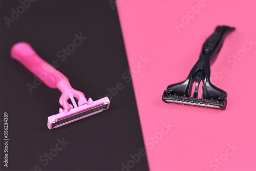 Gender stereotypes concept showing pink and black razor aimed at specific genders  photo