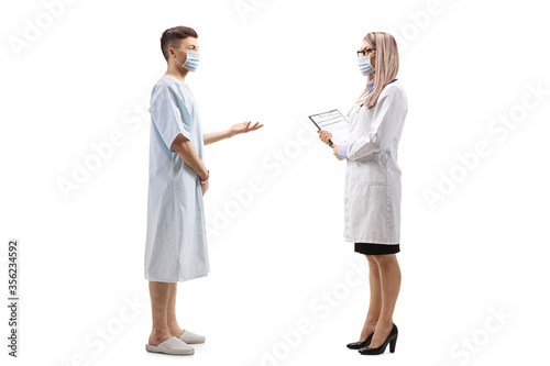 Young male patient talking to a female doctor and wearing protective masks