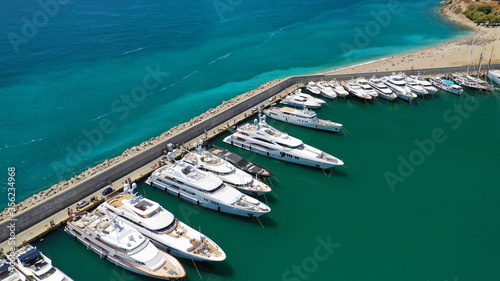 Aerial drone top down photo of luxury yacht anchored in Mediterranean bay marina