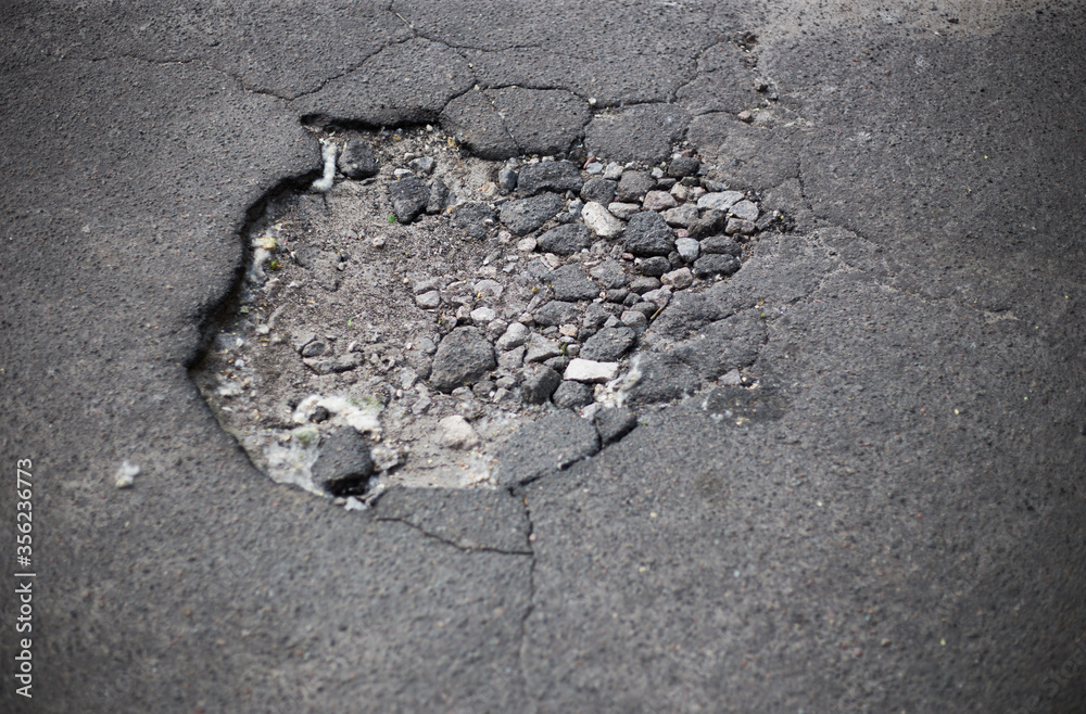Broken asphalt and cracks on the road surface Broken asphalt and cracks on the road surface