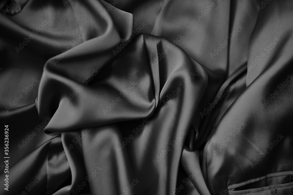 Fototapeta premium The fabric is silk. Silk drapery. The silk is beige. The cloth.black and white image.