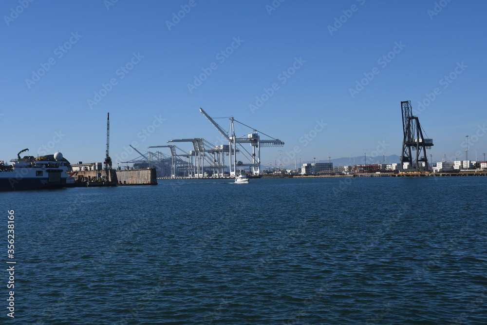 Super Post Panamax cranes at the Port of Oakland. The giant cranes at the apex are roughly the height of a 24 story building and can weigh 1600 to 2000 tons each.