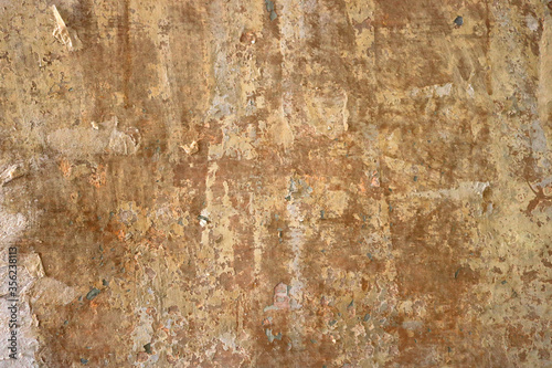 old vintage and creepy wall of paper with an interesting abstract texture and brown and golden background color - weathered wallpaper 