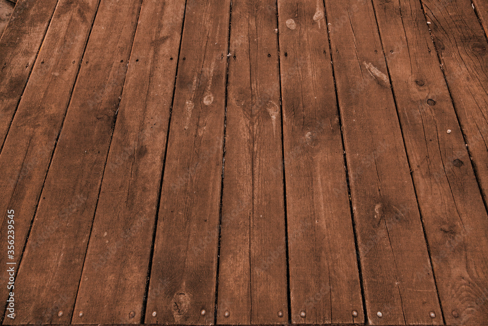 Brown wooden vertical plank fence. Brown wooden vertical plank fence.