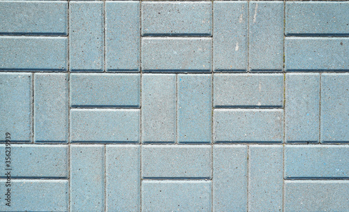 Stone pavement texture. Granite cobblestoned pavement background. Blue brick stone background. Top view