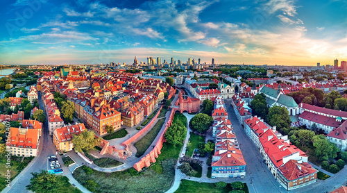 Beautiful panoramic aerial drone view on Warsaw Old town (POL: Stare Miasto) - the oldest district of Warsaw (13th century), Royal Castle, square and the Column of Sigismund III Vasa at sunset, Poland