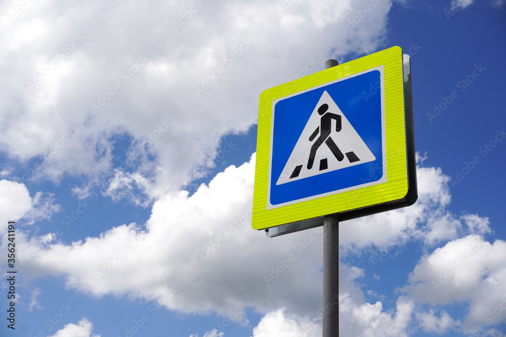 Road sign pedestrian. Pedestrian transit traffic sign on sky background, the concept of road safety Road sign pedestrian. Pedestrian transit traffic sign on sky background, the concept of road safety