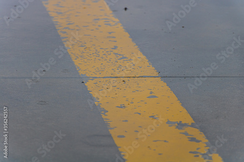 Yellow Strip on Grey Concrete During Rain Day