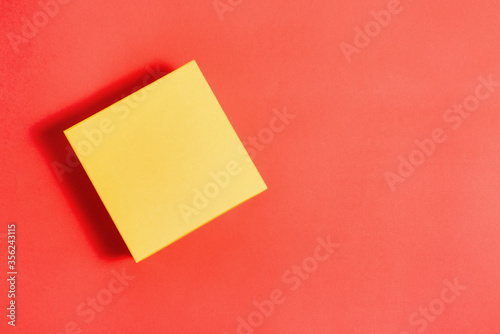 Color closed box on a creative background. Gift box for a holiday or parcel delivery. Concept of delivery of goods by mail. Top view, copy of the space.