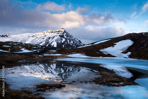 Icelandic landscape with frozen lake and stapafell mountain covered in snow snaefellsnes peninsula in Iceland © Michalis Palis