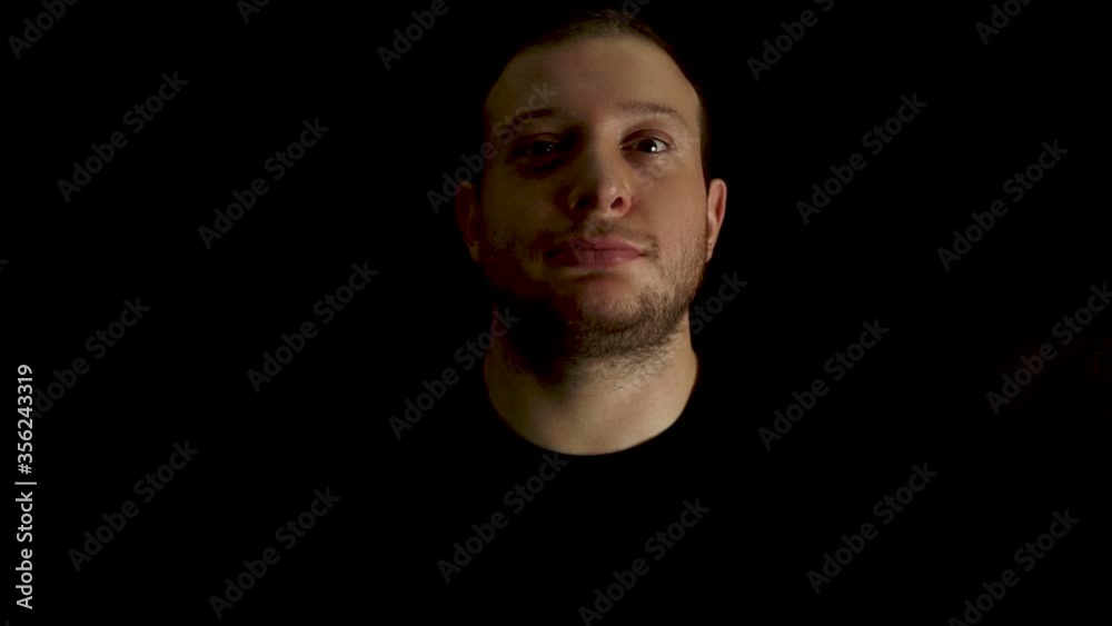 Portrait of young, bored man on black background. Tired and outworn concept. Portrait of young, bored man on black background. Tired and outworn concept.
