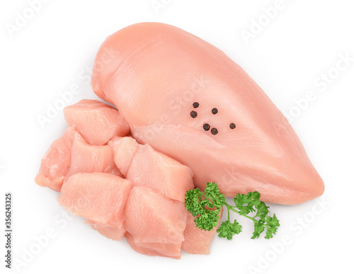 Fresh diced chicken fillet with parsley isolated on white background with clipping path and full depth of field. Top view. Flat lay