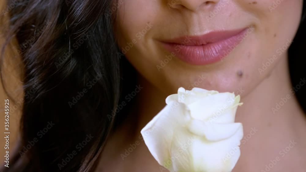 Beautiful young woman with white rose, closeup Beautiful young woman with white rose, closeup