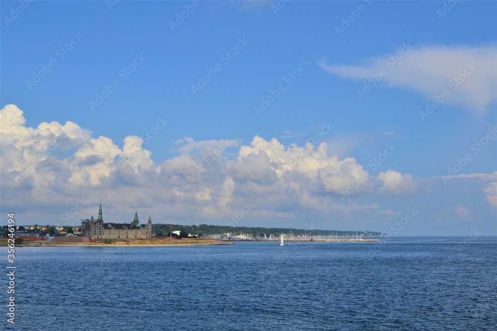 Denmark. Landscape in blue tones of the sky and water. The coast of Copenhagen is visible in the distance