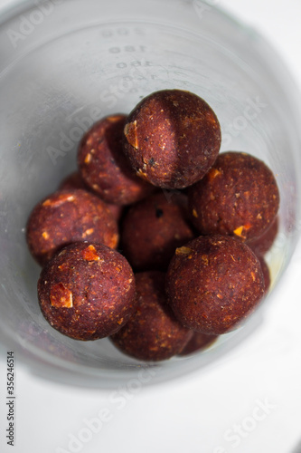 brown fishing boilies in a transparent jar