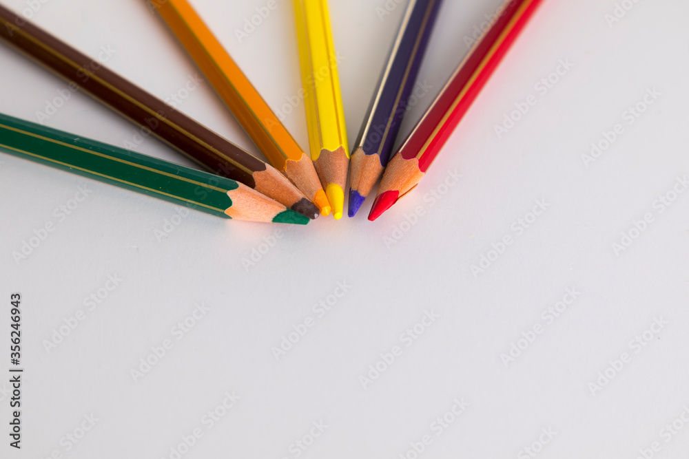 Colored pencils, united at point, on white background Colored pencils, united at point, on white background