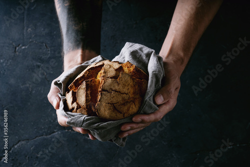 Traditional Portuguese round bread in male hands