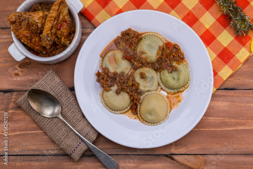 Wallpaper Mural Sorrentinos, stuffed pasta, with sauce on wooden table Torontodigital.ca