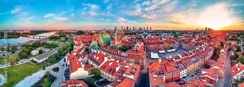 Beautiful panoramic aerial drone view on Warsaw Old town (POL: Stare Miasto) with modern skyscrapers on the horizon, Royal Castle, square and the Column of Sigismund III Vasa at sunset, Poland
