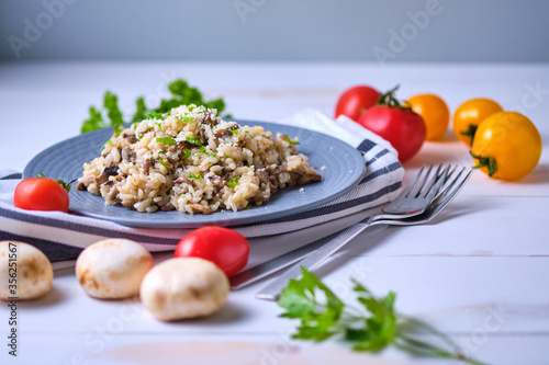 Mushroom risotto garnished with fresh parsley and grated parmesan.