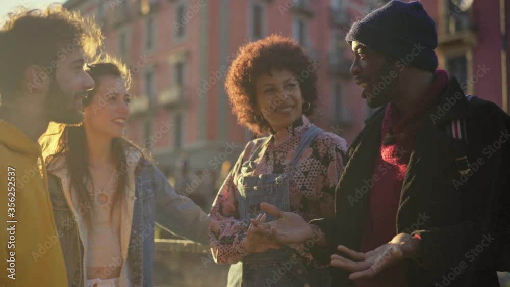 MS Group of friends talking and laughing outdoors / Milan, Italy