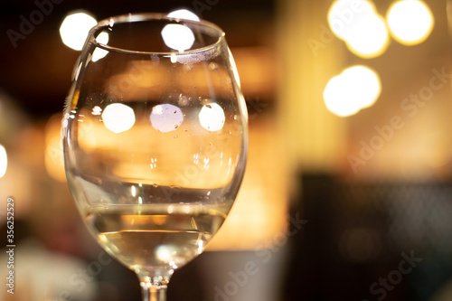 soft focus wine glass banquet hall event concept indoor space view with gold lighting and bokeh background