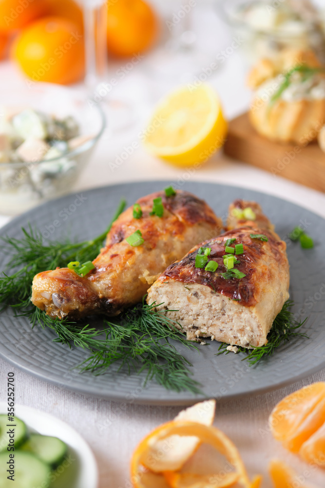 Chicken legs stuffed with meat, mushrooms and cheese. Tasty and beautiful dish on the holiday table.