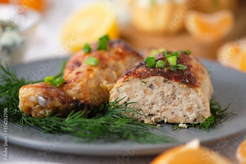 Chicken legs stuffed with meat, mushrooms and cheese. Tasty and beautiful dish on the holiday table.