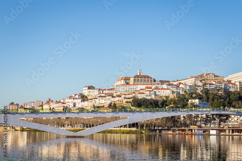 historic Coimbra cityscape with university at top of the hill in the evening  Portugal