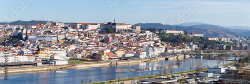 historic Coimbra cityscape with university at top of the hill in the evening, Portugal